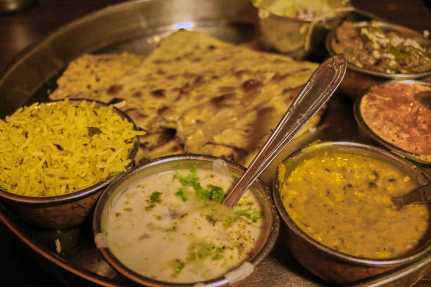 Closeup of colorful Thali set meal with a yellow rice, a dal and delicious sauces from Amritsar, India.
