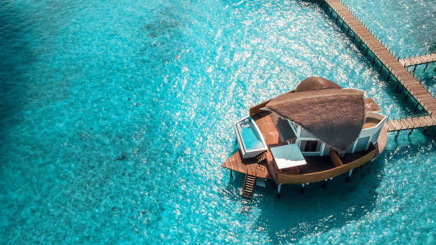 Luxurious Maldives Island Resort Water Villas from above. Over Water Villas are typical for Maldives resorts