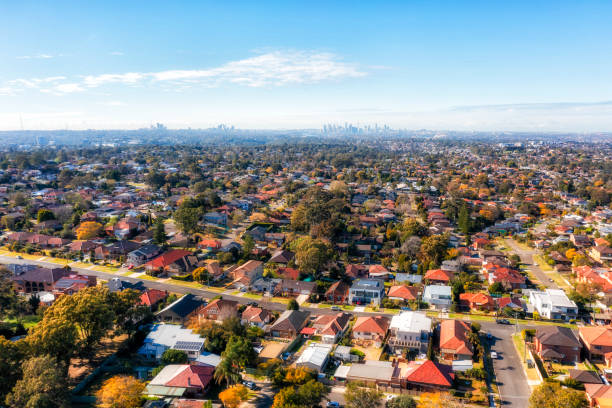 City of Ryde residential suburbs of Greater Sydney in Australia - aerial view towards distant city CBD on horizon.