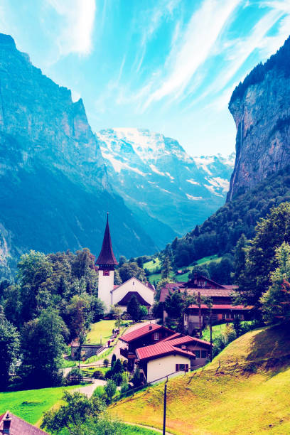 The Incredible picturesque landscape in Lauterbrunnen with canyon, church and famous Staubbach waterfall in the Swiss Alps, Switzerland. Amazing places.