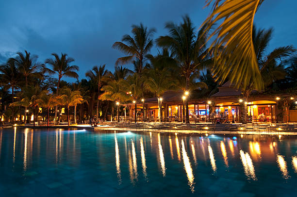 Bar under open sky besides a pool.