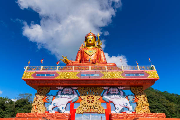 Holy statue of Guru Padmasambhava or born from a lotus, Guru Rinpoche, was a Indian tantric Buddhist Vajra master who taught Vajrayana in Tibet. Blue sky and white clouds, Samdruptse, Sikkim, India.