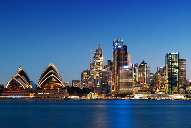 The Sydney Opera House and Circular Quay district at dusk.