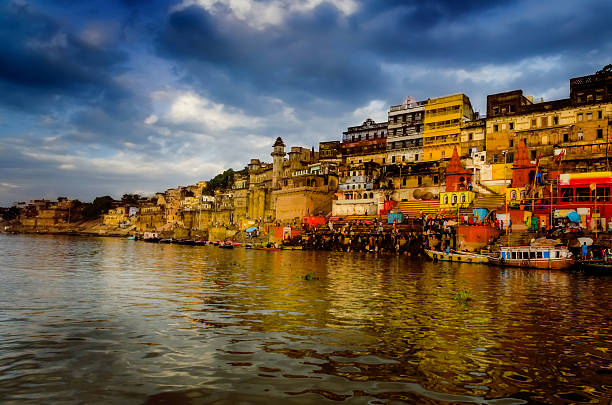 big wooden boats in water with cloudy sky and sunbeams at allahabad indian asia