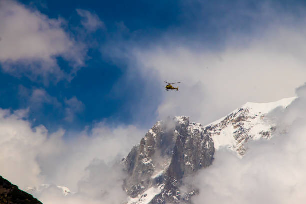 Image of a helicopter flying on a mountain area
