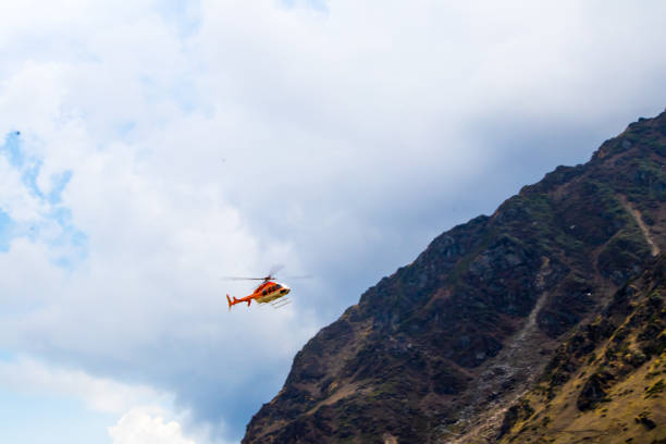 Image of a helicopter flying on a mountain area